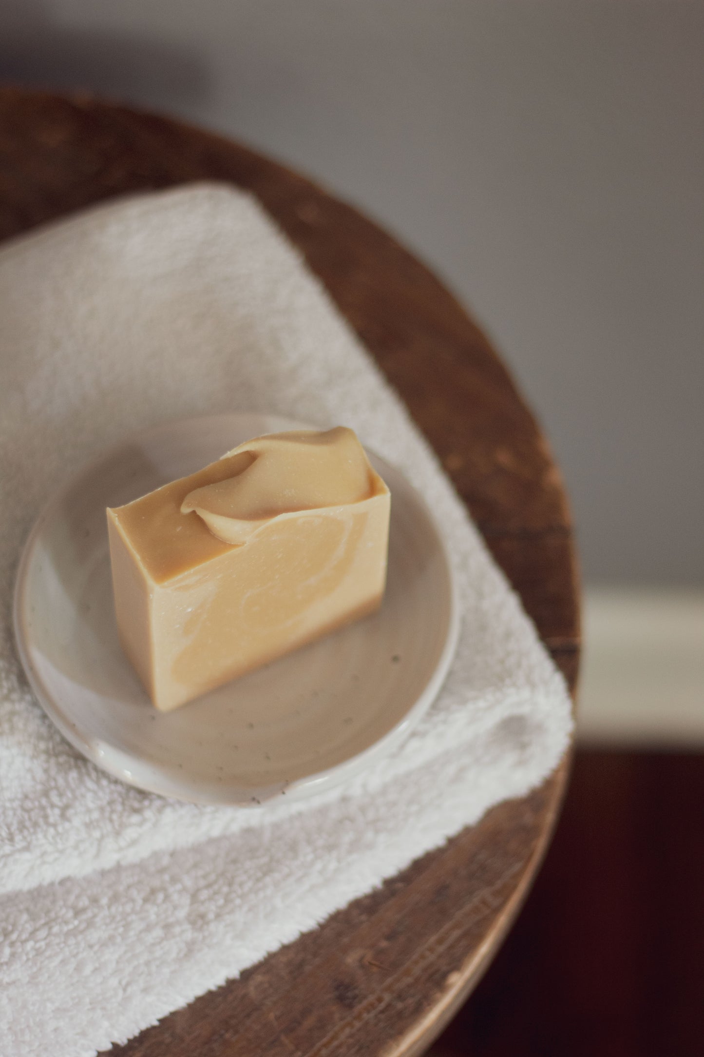 Vanilla Woods bar soap on a folded white towel