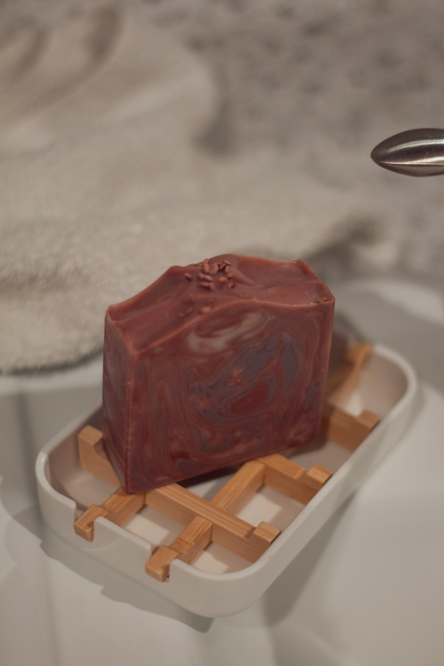 Mulled Orchard bar soap in a dish on a waffle-weave towel