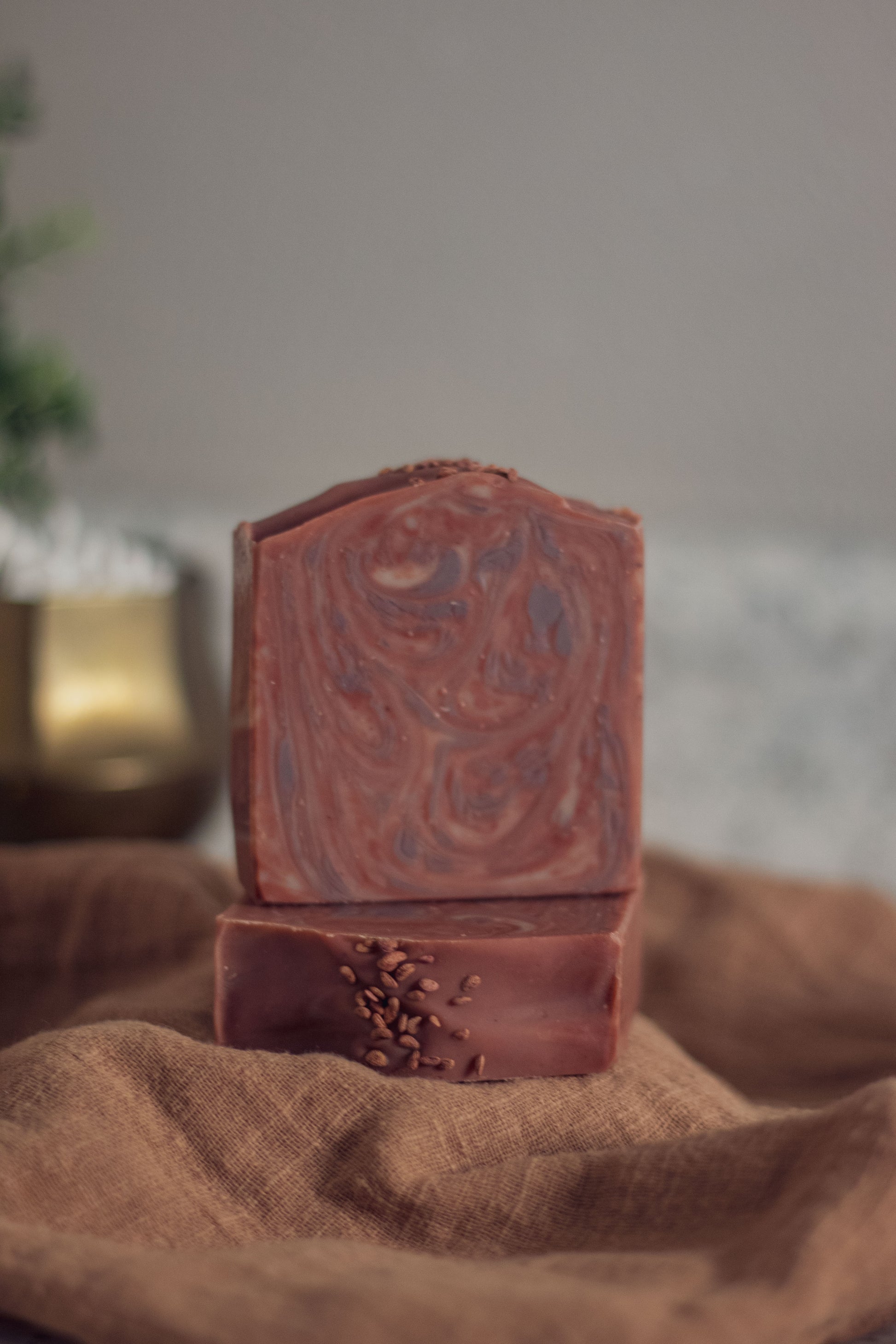 Mulled Orchard bar soap standing upright on burlap fabric