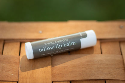 Vanilla Woods tallow lip balm tube lying flat on a wicker basket