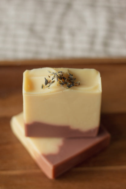 Lemon + Lavender soap bars stacked at an angle, showing the swirled cream and mauve layers